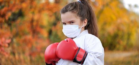 little girl in mask and kickboxing gear